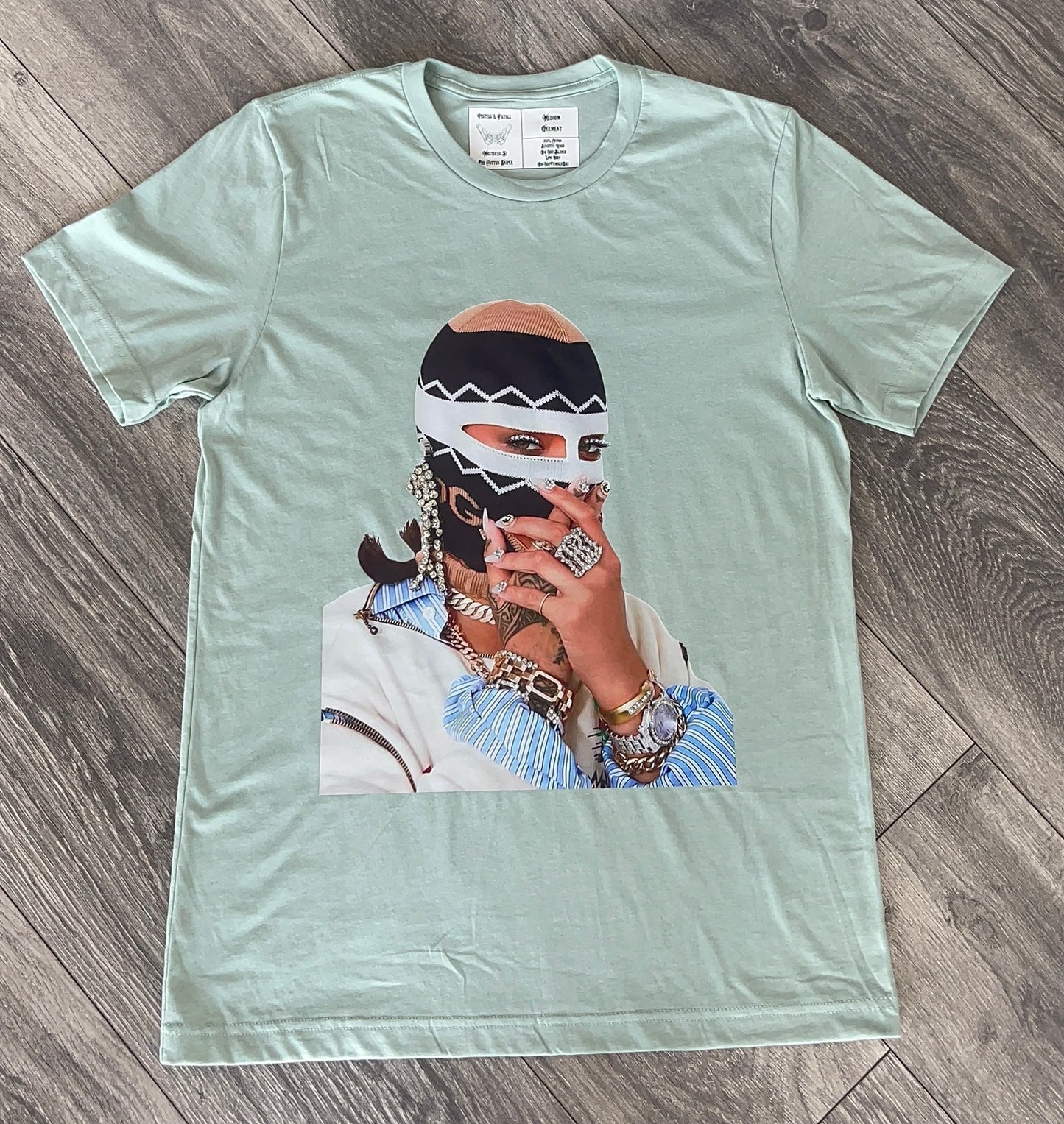 Full-view flat lay of the seafoam green Pastels & Pistols “Say Less” rhinestone tee.
