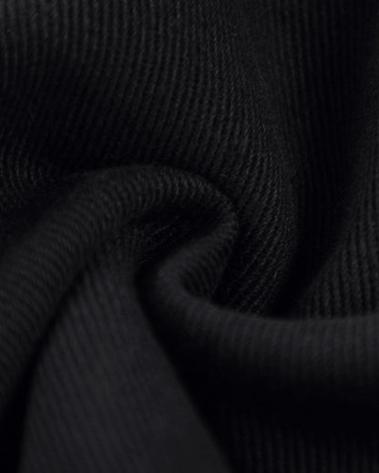     Close-up of black denim fabric texture used on Pastels & Pistols Rivet Denim Mini Skirt 