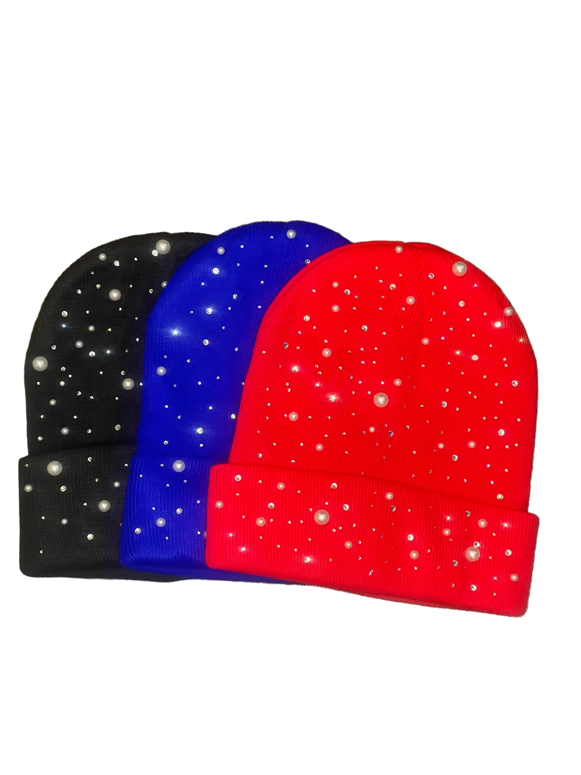 Pastels & Pistols Rhinestone & Pearl Knitted Beanie in black, blue, and red. Soft knitted winter hats with rhinestone and pearl embellishments. Studio product photo on white background for online shopping search visibility.
