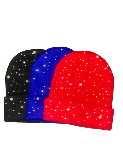 Pastels & Pistols Rhinestone & Pearl Knitted Beanie in black, blue, and red. Soft knitted winter hats with rhinestone and pearl embellishments. Studio product photo on white background for online shopping search visibility.
