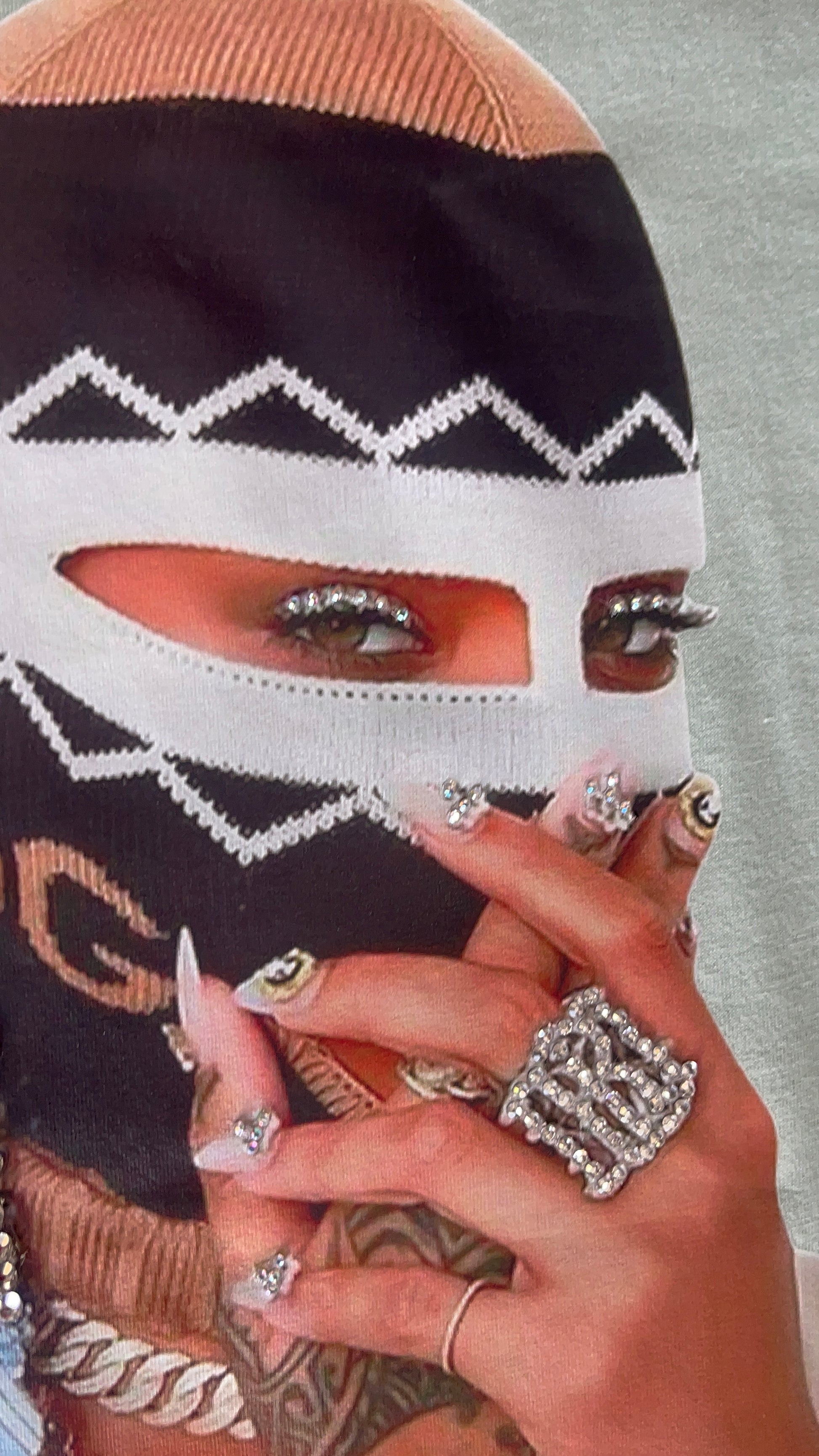 Close-up of eye section of the graphic with rhinestone accents on the Pastels & Pistols “Say Less” Tee.