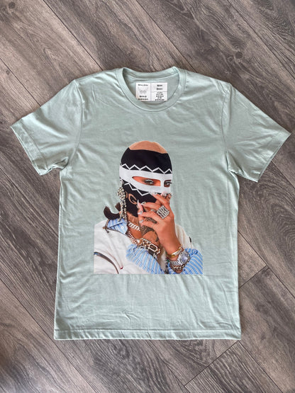 Pastels & Pistols “Say Less” seafoam green rhinestone tee shown on flat lay angled view.